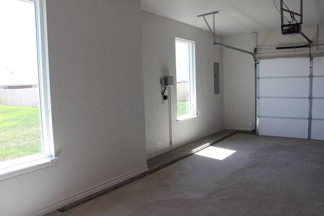 8104 Miami Ave, Amarillo, TX 79118 - garage with electric panel, a garage door opener, and baseboards