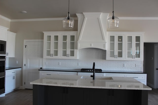 8104 Miami Ave, Amarillo, TX 79118 - kitchen with custom range hood, crown molding, backsplash, dark wood-type flooring, and white cabinetry