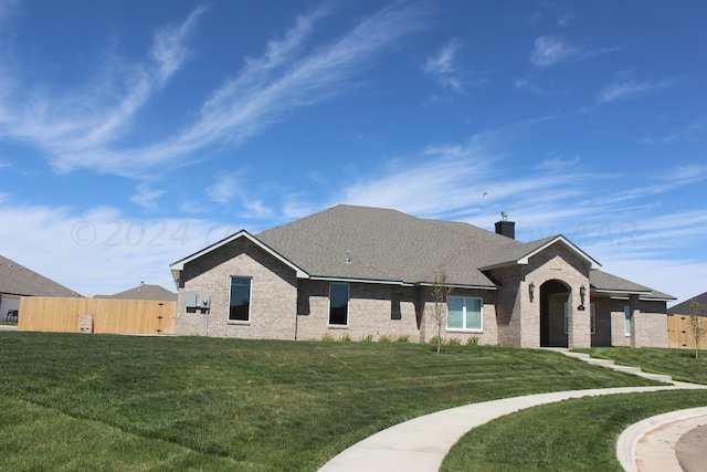 8104 Miami Ave, Amarillo, TX 79118 - view of front of home featuring brick siding, a shingled roof, and a chimney