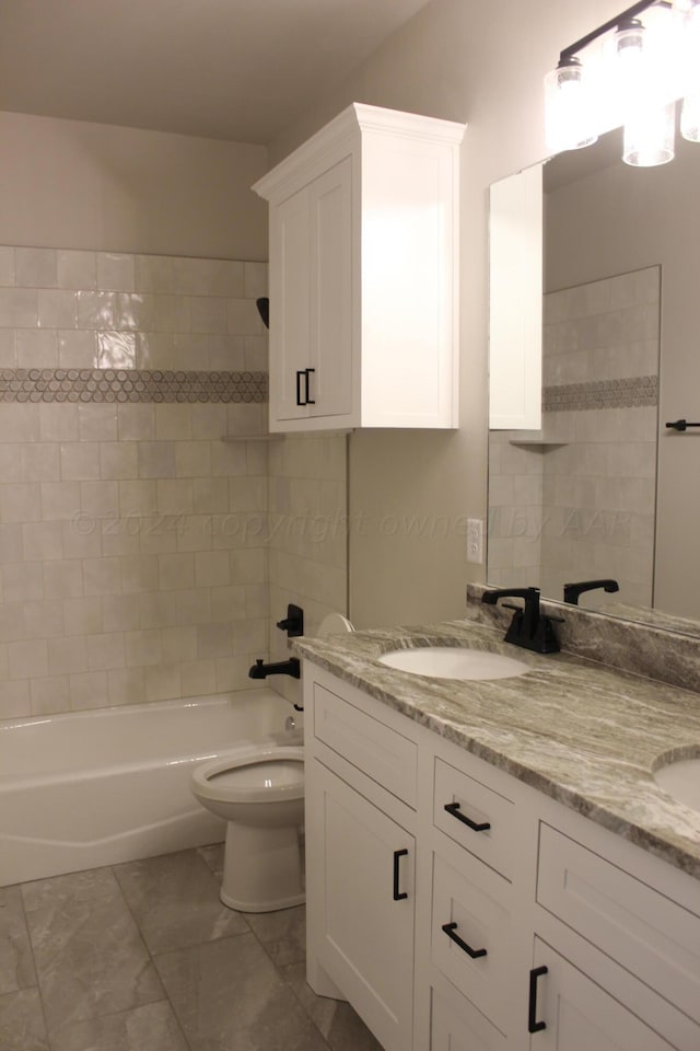 8104 Miami Ave, Amarillo, TX 79118 - full bath with double vanity, marble look tile flooring, toilet, and shower / bathtub combination