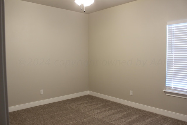 8104 Miami Ave, Amarillo, TX 79118 - empty room featuring dark colored carpet, ceiling fan, baseboards, and plenty of natural light