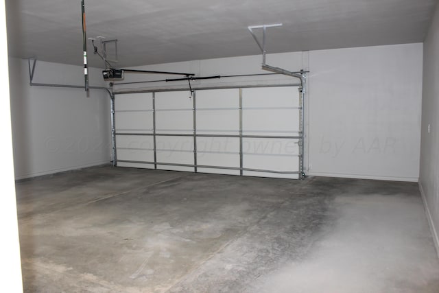 8104 Miami Ave, Amarillo, TX 79118 - garage featuring a garage door opener and baseboards