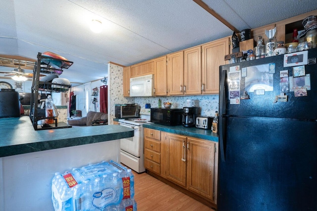 kitchen with dark countertops, black appliances, light wood-type flooring, and ceiling fan