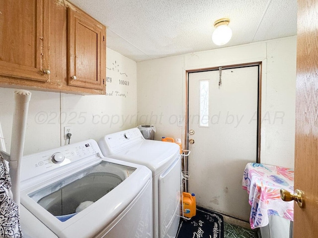 laundry area with cabinet space, a textured ceiling, and independent washer and dryer