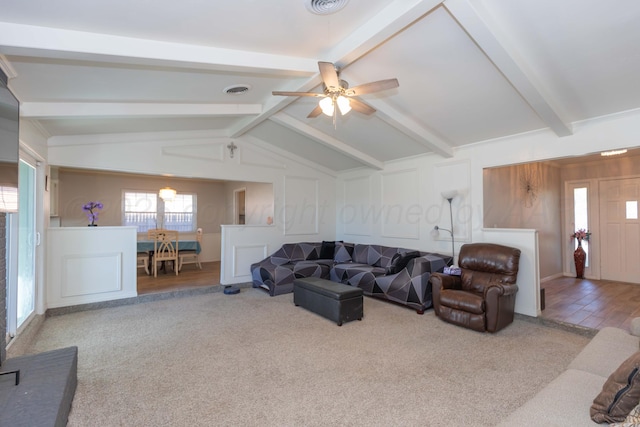 carpeted living area with a ceiling fan