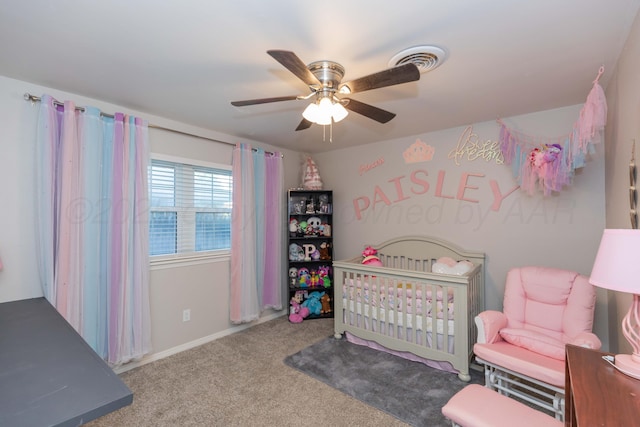 bedroom with carpet floors, a nursery area, and ceiling fan