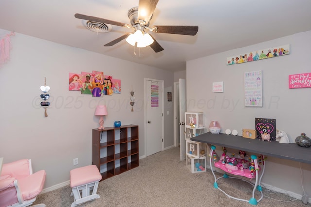 rec room with a ceiling fan, carpet, and baseboards