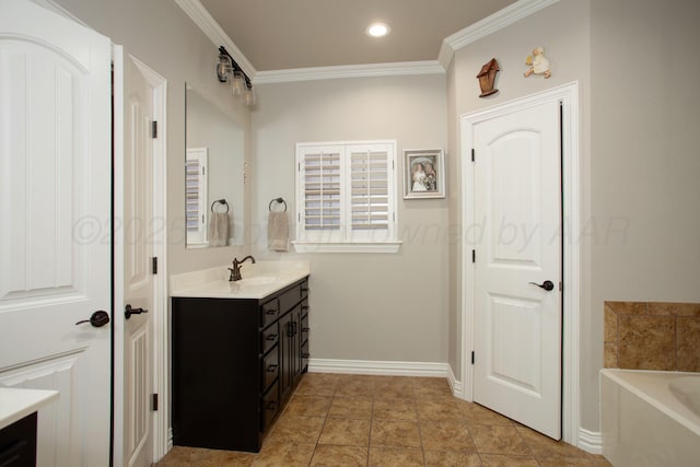 full bath with vanity, a garden tub, crown molding, and baseboards