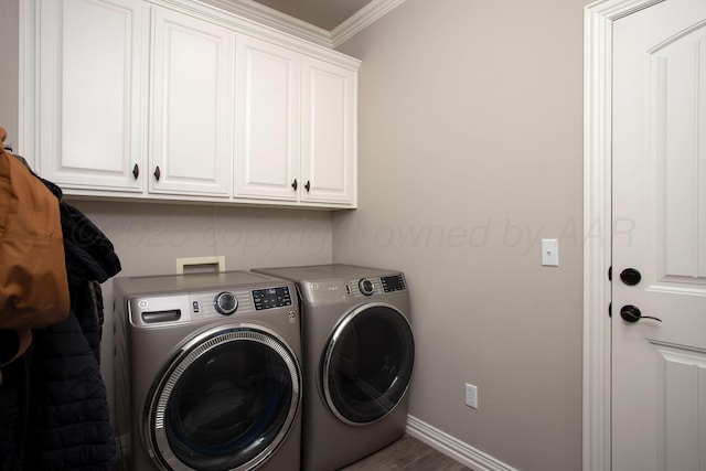 laundry room featuring washer and dryer, cabinet space, crown molding, baseboards, and wood finished floors