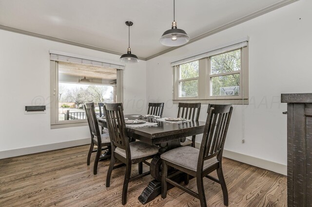 4407 SW 3rd Ave, Amarillo, TX 79106 - dining area with baseboards, crown molding, a healthy amount of sunlight, and wood finished floors