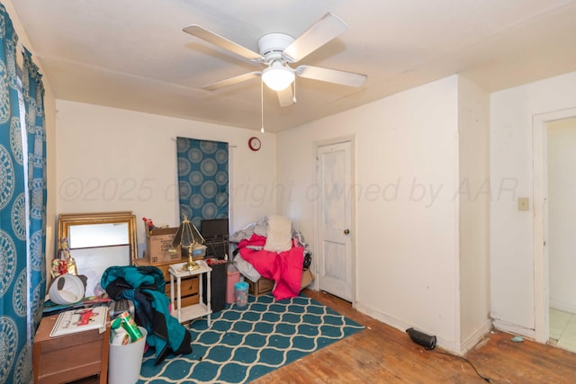 playroom featuring ceiling fan, baseboards, and wood finished floors