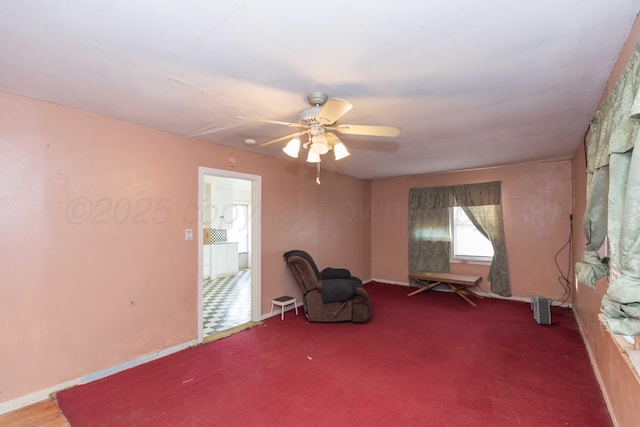 unfurnished room with a ceiling fan, carpet, and baseboards