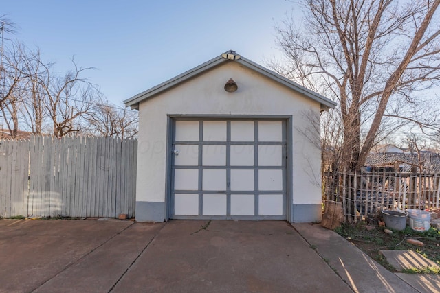 garage with driveway and fence