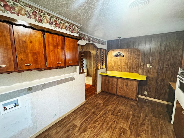 kitchen featuring dark hardwood / wood-style floors, hanging light fixtures, and a textured ceiling