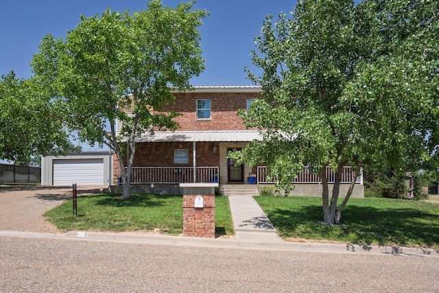 1007 N Jackson St, Amarillo, TX 79107 - view of property featuring covered porch, brick siding, a front lawn, a garage, and driveway