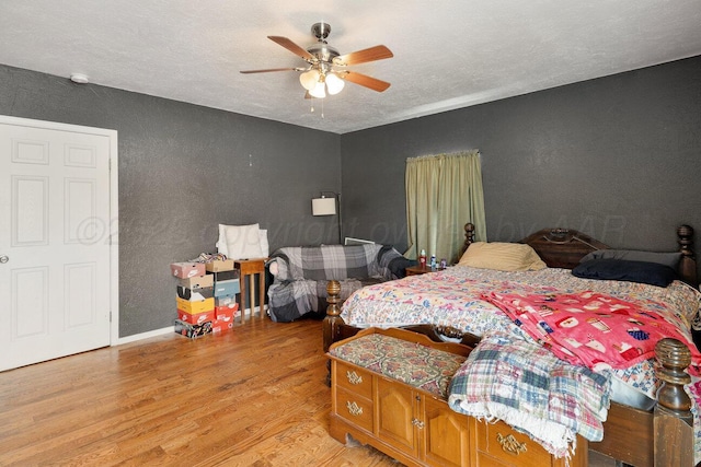 1007 N Jackson St, Amarillo, TX 79107 - bedroom with a textured wall, light wood-style floors, a ceiling fan, and a textured ceiling