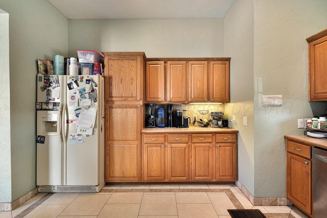 1007 N Jackson St, Amarillo, TX 79107 - kitchen featuring white refrigerator with ice dispenser, light countertops, decorative backsplash, and dishwasher