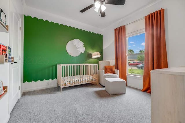 1600 NE 6th St, Dumas, TX 79029 - bedroom with ceiling fan, crown molding, a nursery area, baseboards, and carpet floors