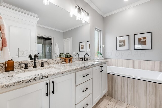 1600 NE 6th St, Dumas, TX 79029 - bathroom featuring a garden tub, a sink, double vanity, and ornamental molding