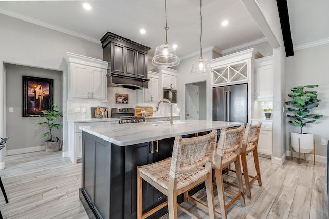 1600 NE 6th St, Dumas, TX 79029 - kitchen featuring crown molding, light stone countertops, a breakfast bar area, a sink, and stainless steel appliances