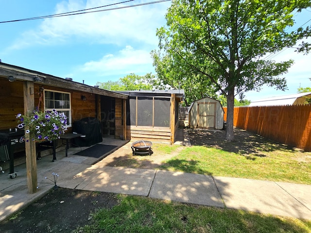 522 N Red Deer St, Pampa, TX 79065 - fenced backyard featuring a fire pit, a sunroom, and a patio area