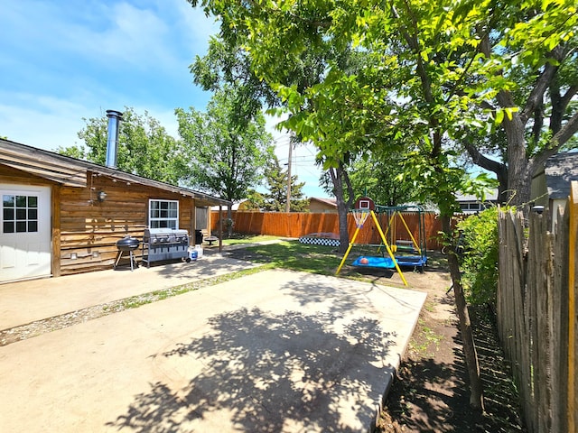 522 N Red Deer St, Pampa, TX 79065 - fenced backyard with a playground and a patio area