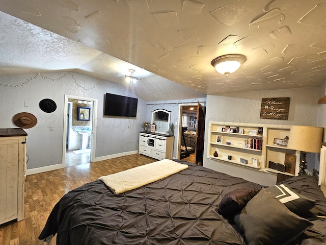 522 N Red Deer St, Pampa, TX 79065 - bedroom with a textured ceiling, lofted ceiling, wood finished floors, and baseboards