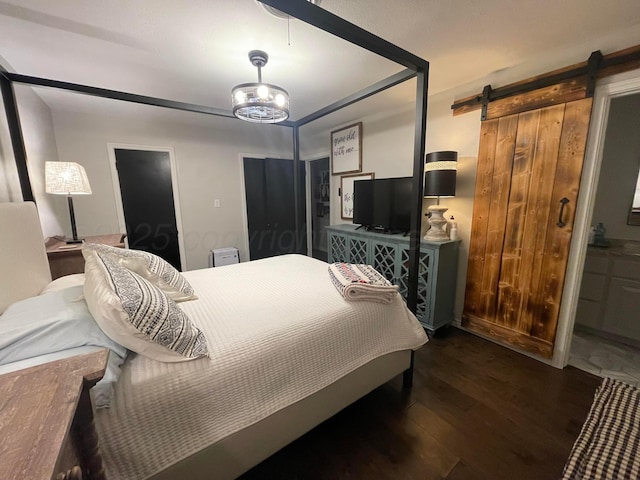 1711 N Holly Ln, Pampa, TX 79065 - bedroom featuring a barn door and wood finished floors