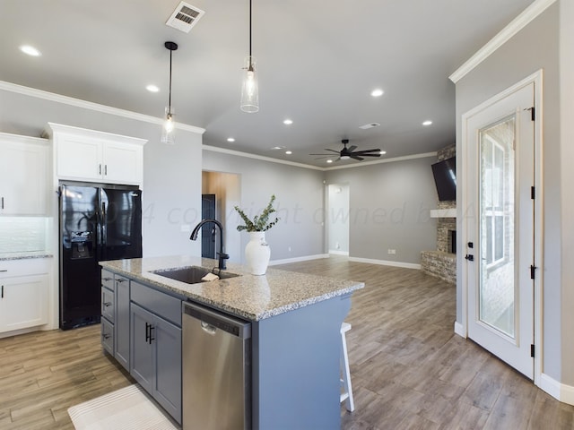 kitchen with ceiling fan, black fridge with ice dispenser, dishwasher, white cabinets, and sink