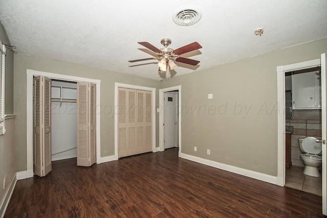 3122 Nebraska St, Amarillo, TX 79106 - unfurnished bedroom with wood finished floors, two closets, ensuite bathroom, a textured ceiling, and a ceiling fan