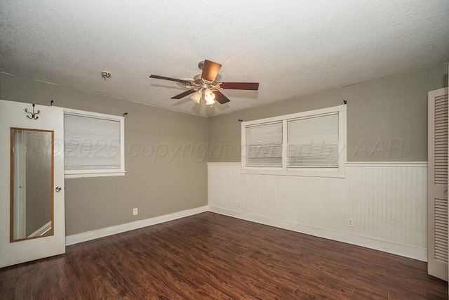 3122 Nebraska St, Amarillo, TX 79106 - unfurnished room featuring ceiling fan, wood finished floors, a wainscoted wall, and a textured ceiling