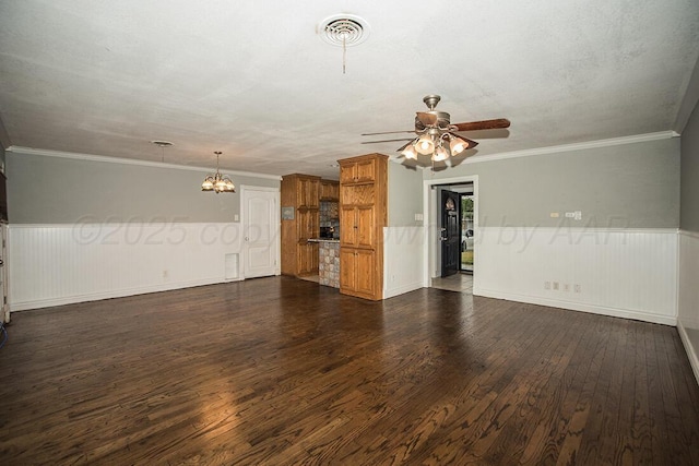 3122 Nebraska St, Amarillo, TX 79106 - unfurnished living room featuring a chandelier, a wainscoted wall, dark wood-style flooring, ceiling fan, and crown molding