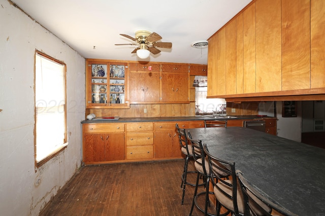 506 E 5th St, Sunray, TX 79086 - kitchen with dark wood-type flooring, visible vents, brown cabinets, and ceiling fan