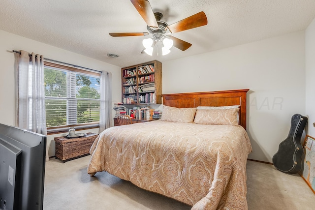300 W 11th St, Wheeler, TX 79096 - bedroom featuring light colored carpet, a textured ceiling, and ceiling fan