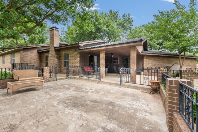 300 W 11th St, Wheeler, TX 79096 - rear view of property with brick siding, a patio, and a chimney