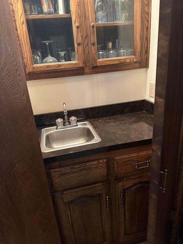 kitchen featuring dark brown cabinetry and sink