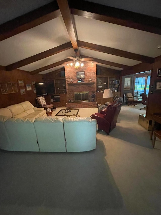 living room with carpet, ceiling fan, vaulted ceiling with beams, and a brick fireplace