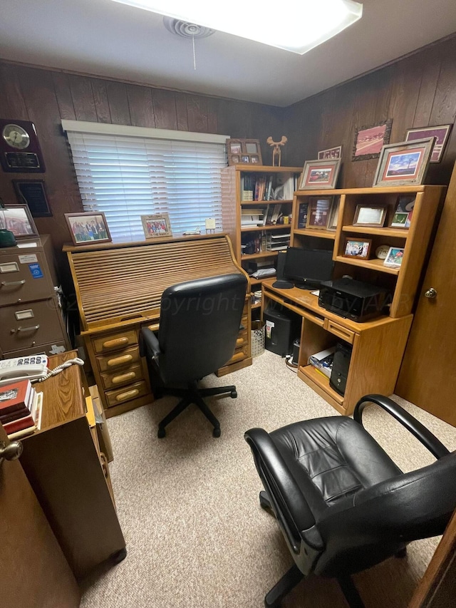 carpeted office featuring wood walls