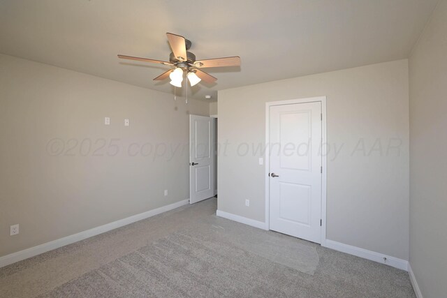 unfurnished bedroom featuring carpet floors, baseboards, and ceiling fan