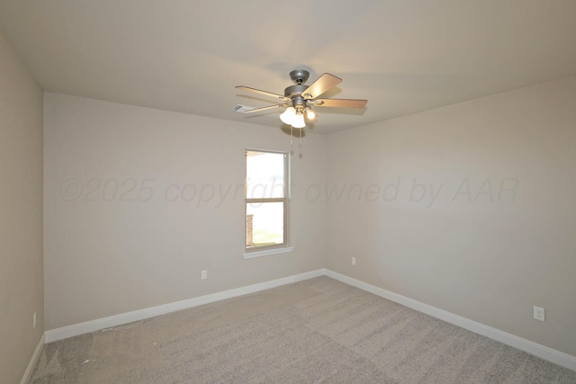 carpeted spare room featuring baseboards and ceiling fan