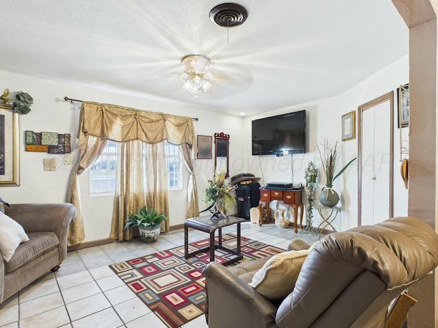 living room featuring a ceiling fan, light tile patterned floors, and visible vents