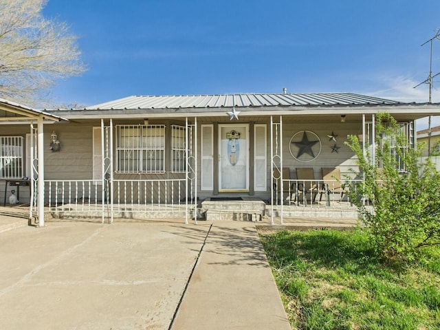 view of front facade with metal roof and a porch