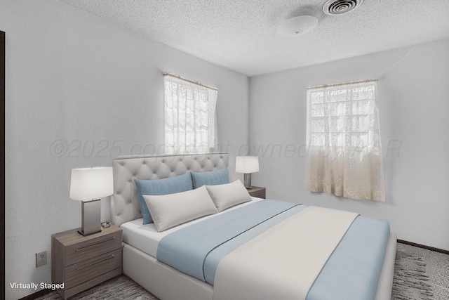 carpeted bedroom with visible vents and a textured ceiling