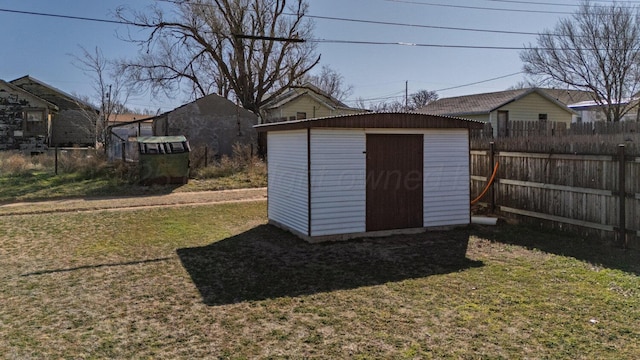 view of shed featuring fence