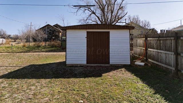 view of shed featuring fence