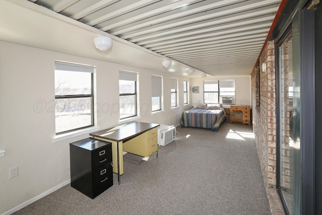 unfurnished bedroom with carpet floors, track lighting, and cooling unit