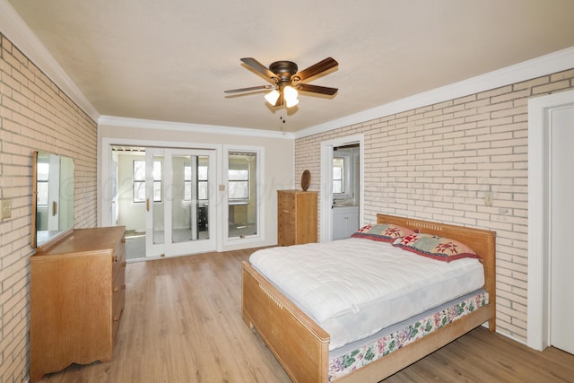 bedroom featuring ornamental molding, light hardwood / wood-style floors, ceiling fan, and brick wall