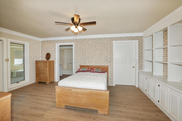 bedroom featuring ornamental molding, brick wall, ensuite bath, and light hardwood / wood-style flooring