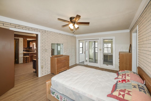 bedroom with wood-type flooring, brick wall, ceiling fan, and crown molding