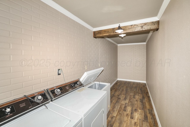 washroom with separate washer and dryer, crown molding, dark hardwood / wood-style flooring, and brick wall